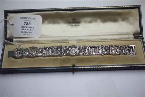 An attractive 1930s/1940s Art Deco white gold and diamond encrusted bracelet in Jays of London fitted box, 7in.
